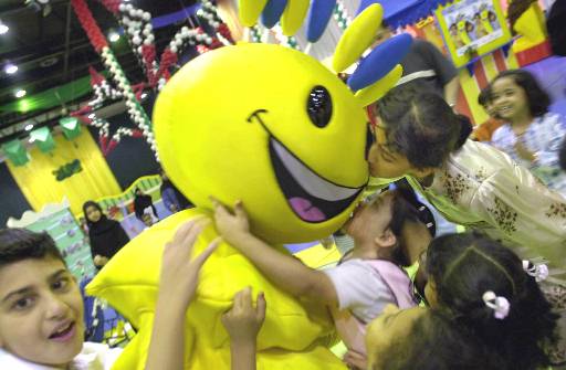Arab children play with Modhesh, the cartoon character at the Modhesh during the Dubai Summer Surprise in Dubai