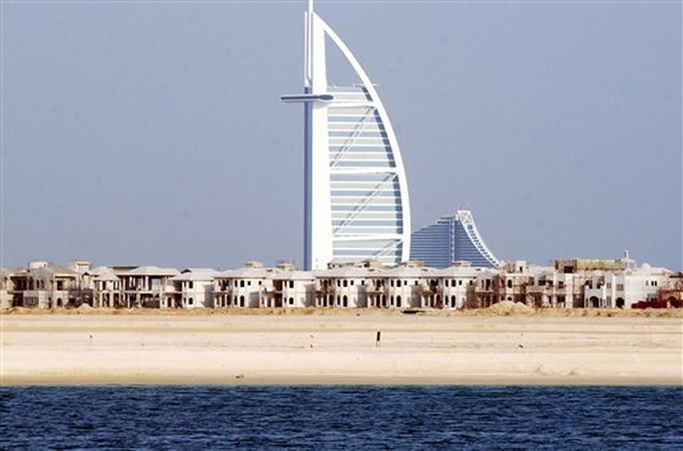 Luxury villas are under construction on Palm Island as the Burj Al Arab, a seven star hotel looks in background in this photo taken in December 2004, Dubai, United Arab Emirates. (photo id 1464586)