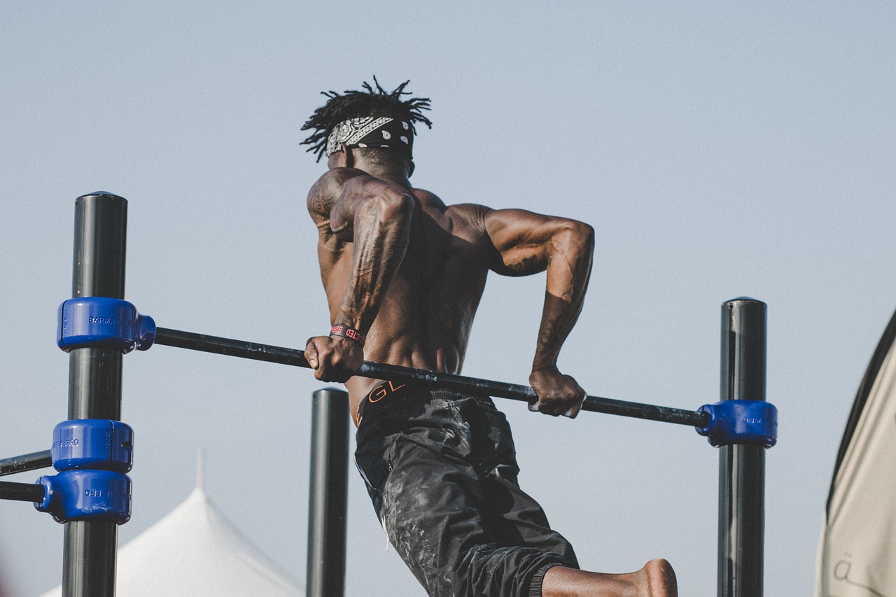 A man working out on one of the pieces of equipment outdoors