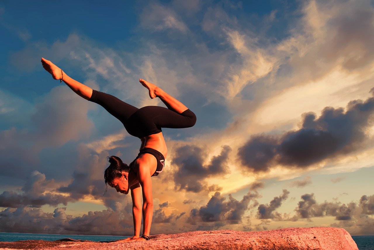 A woman practicing yoga outside as one of the safe ways to stay fit in Dubai.