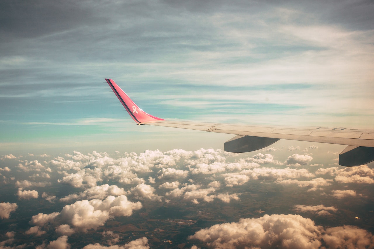 Airplane wing over clouds