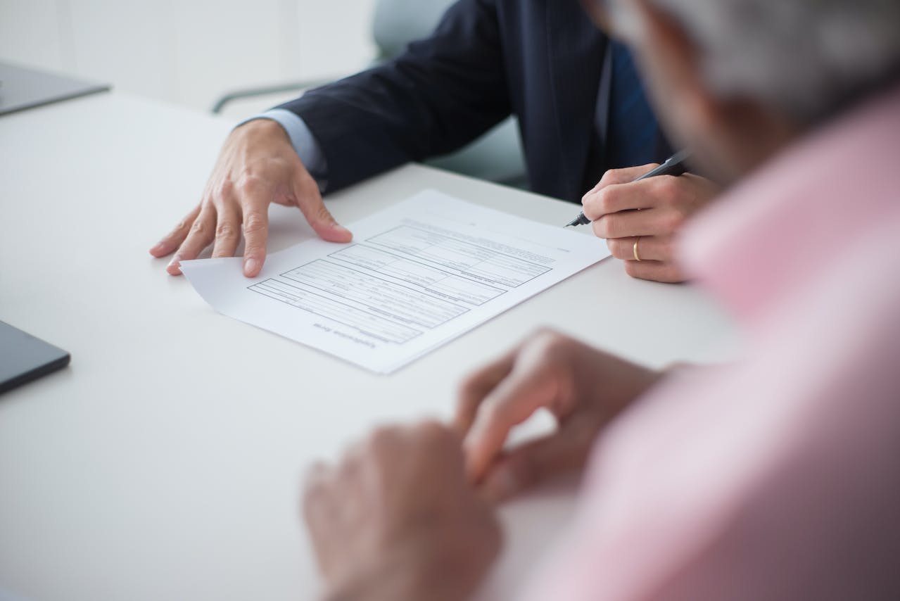 man signing a document