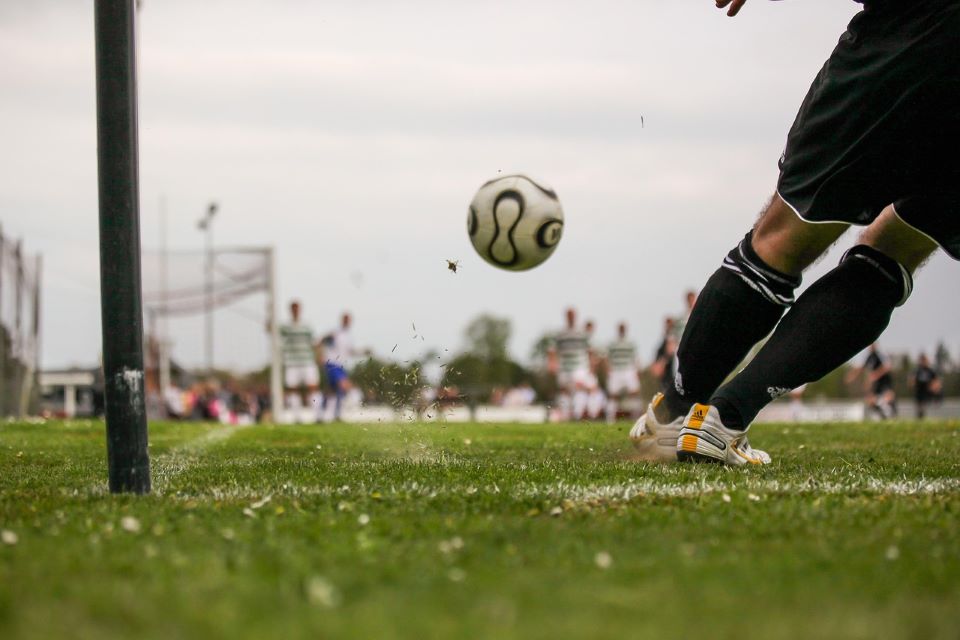 Man kicking soccer ball
