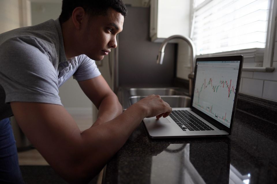 man doing trading on laptop